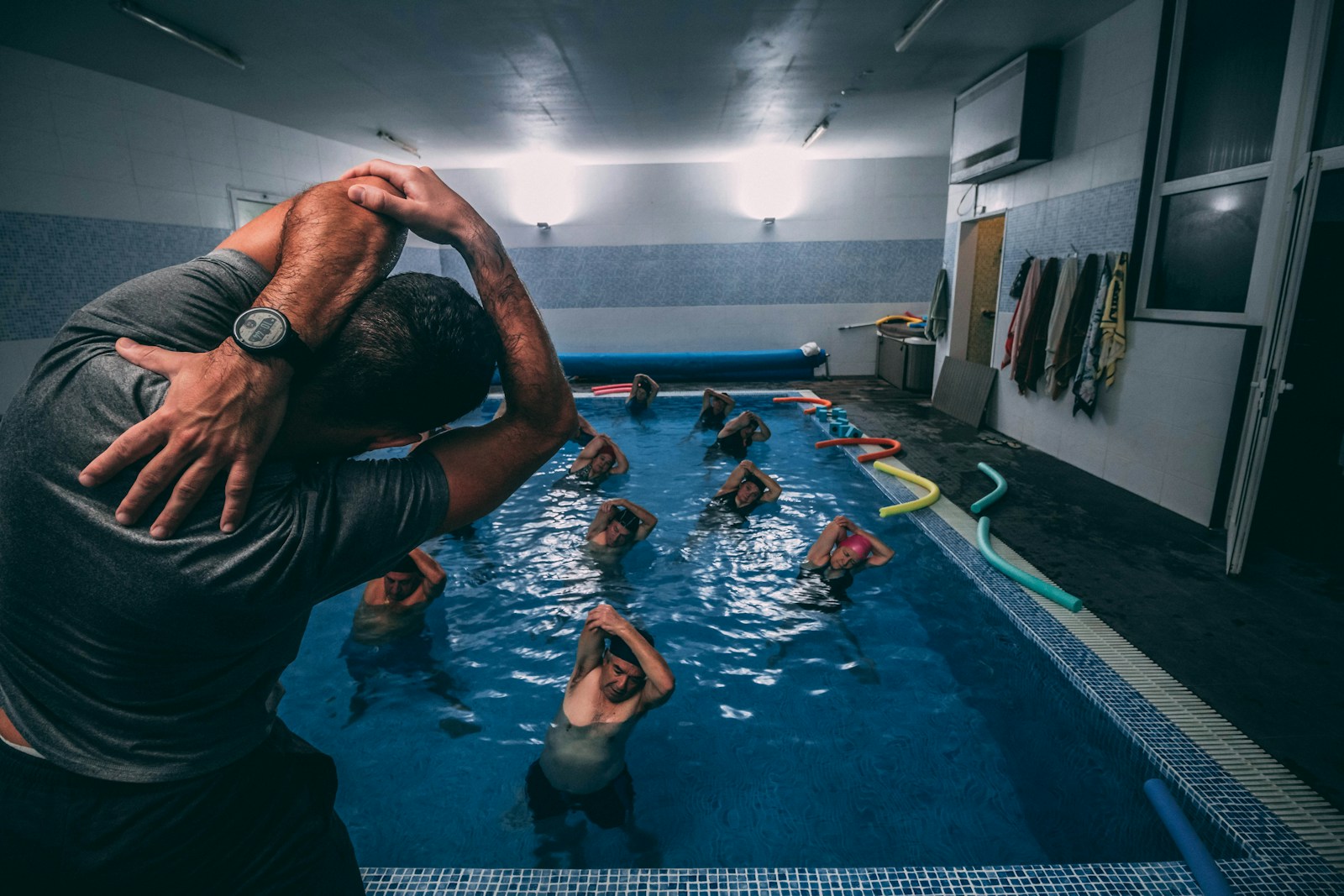 people stretching inside pool room