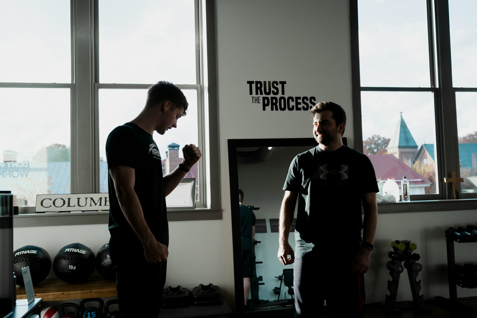 a couple of men standing in front of a window